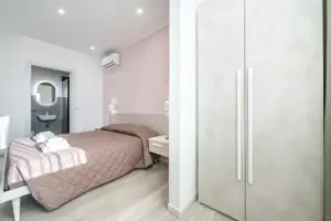 a bedroom with a bed and a closet