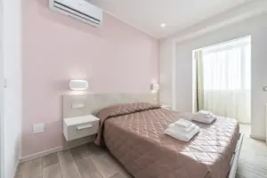 a bed with pink walls and a pink wall