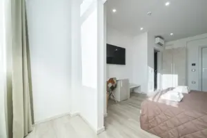 a room with a bed and a tv