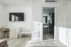 a room with a tv and a sink