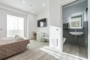 a bedroom with a bed and a sink